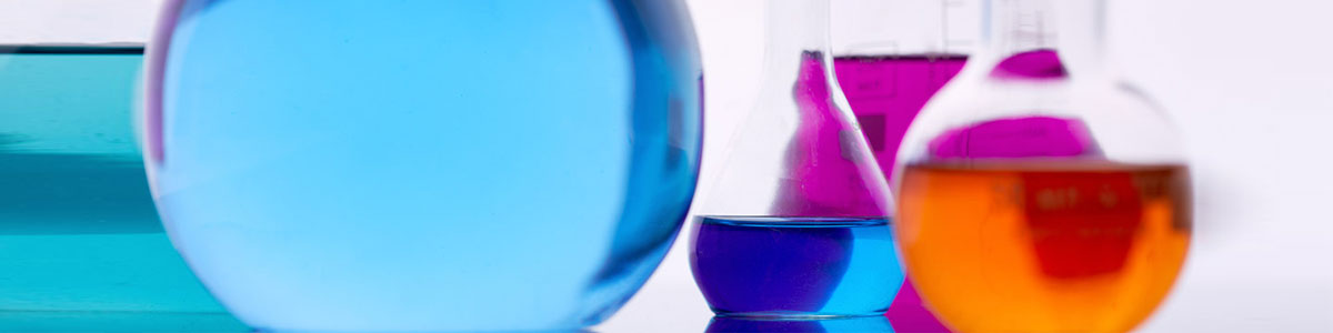 Round beakers with blue, orange, purple liquid.